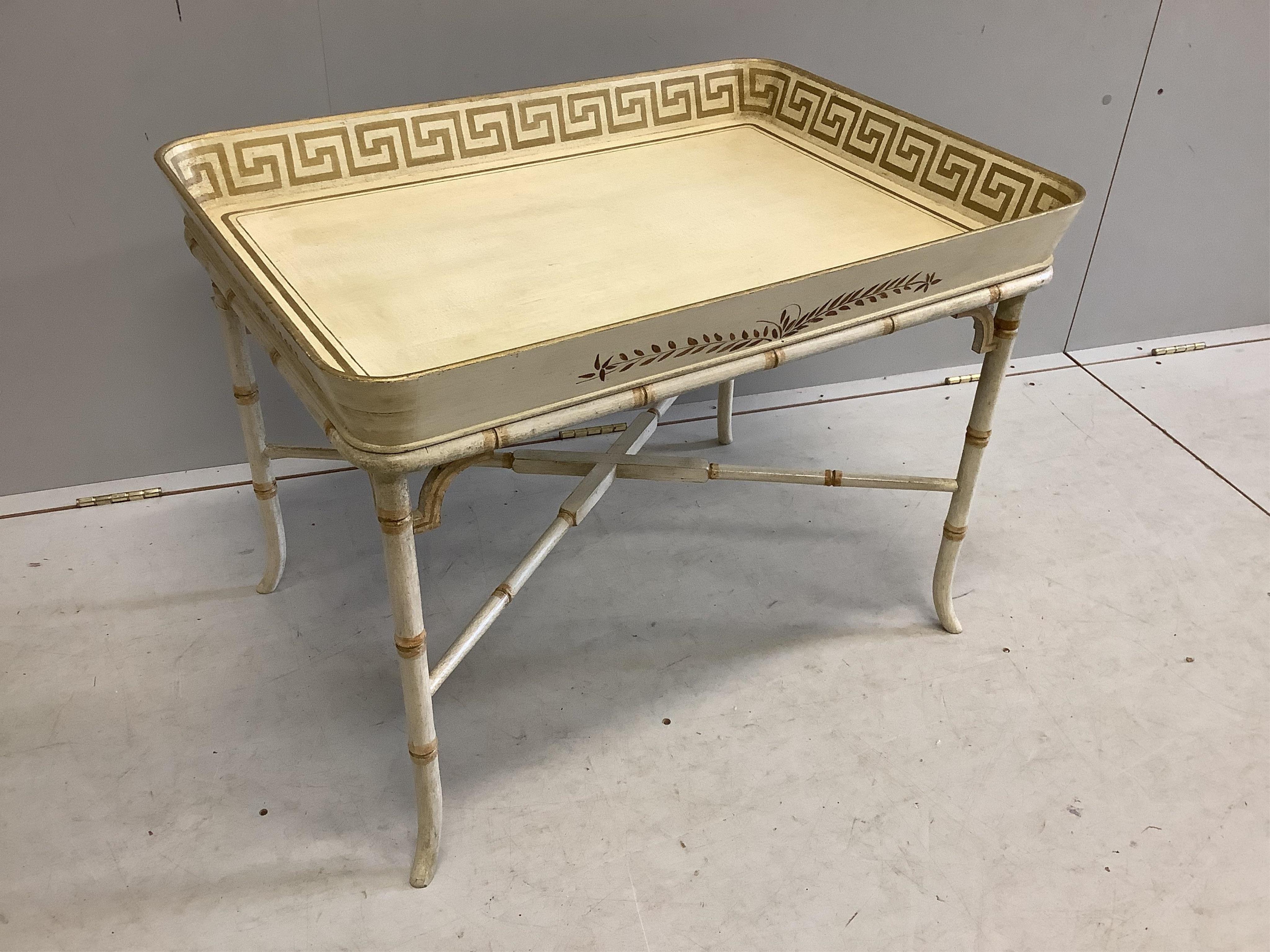 A Regency style rectangular cream painted tray top table, with faux bamboo stand, width 77cm, depth 55cm, height 58cm. Condition - good